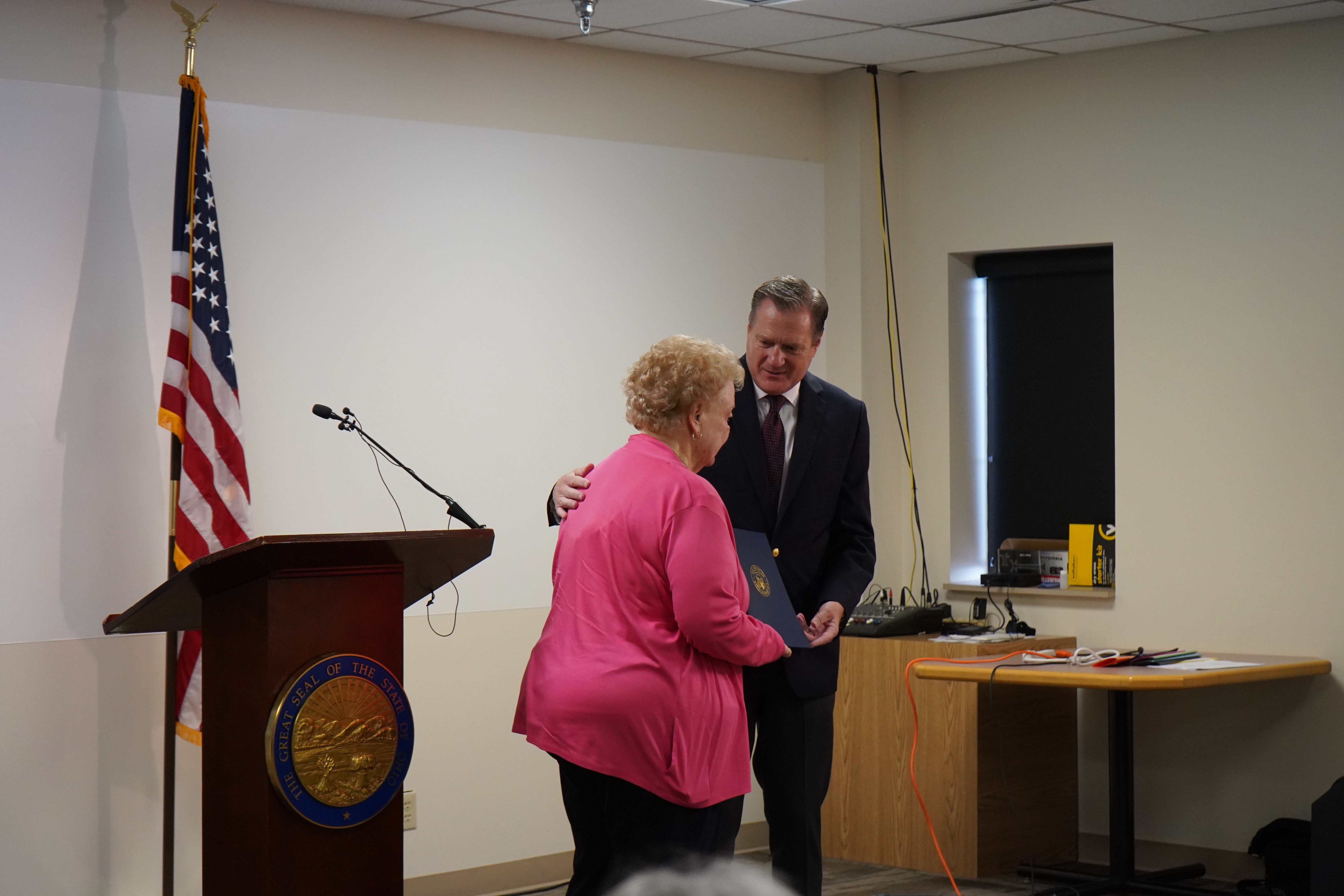 Congressman Mike Turner presents Mayor Church's wife, Judi Church, with a copy of the tribute he inserted into the Congressional Record about Mayor Dick Church.